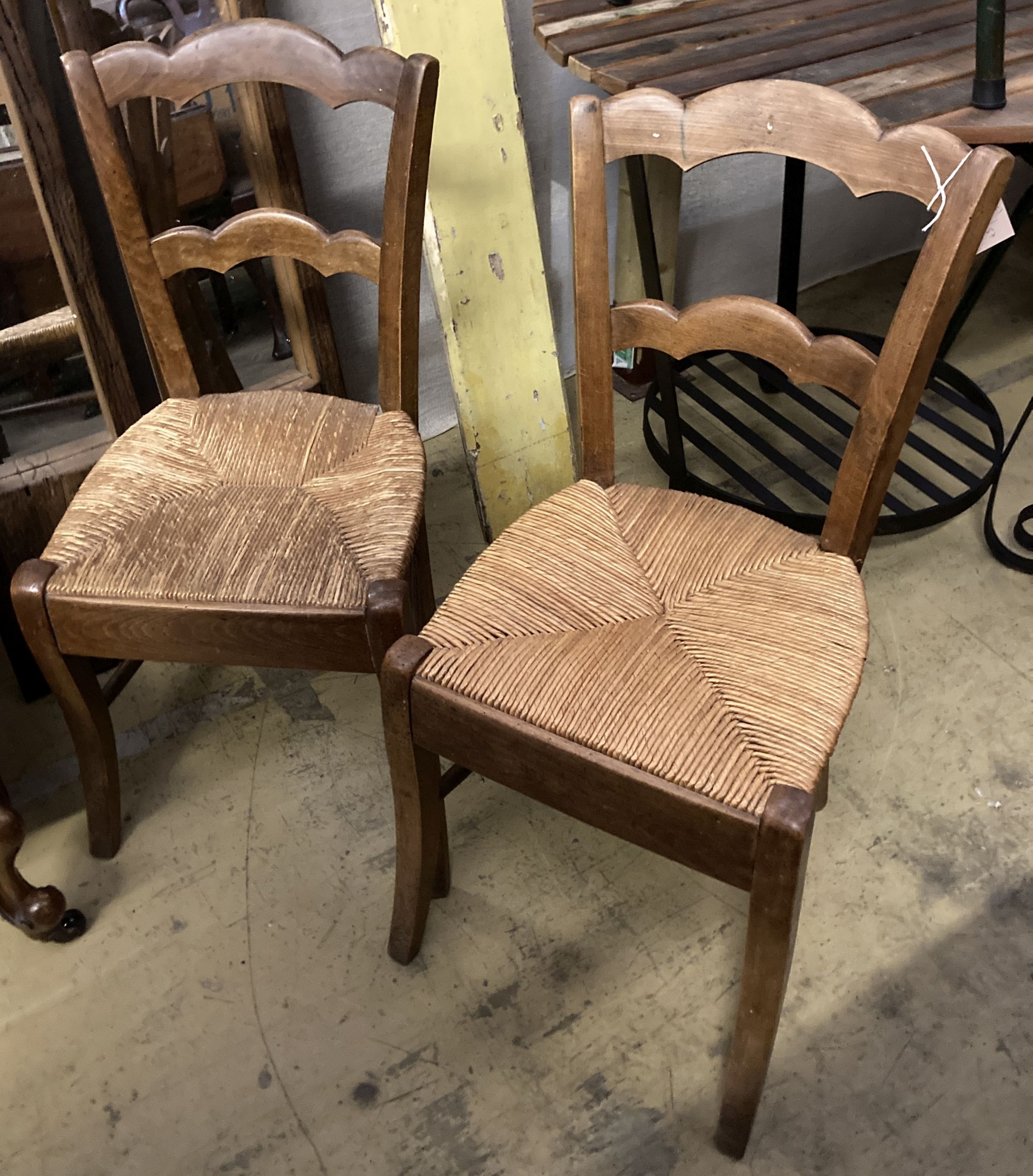 A set of four 19th century French beech rush seat dining chairs